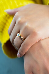 rings in hands, Young bride wearing beautiful engagement ring, close up
