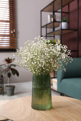Beautiful gypsophila flowers in vase on table indoors