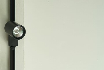 A ceiling spot light install on a house beam.