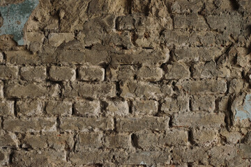 Structure of old stone damaged ancient brick wall and plaster for texture background closeup.