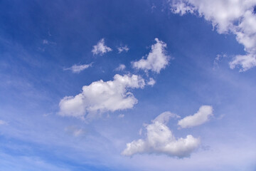 White clouds on blue sky background.