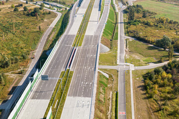 Highway or Freeway road. Wide road with many lanes. Highway for any transportation. Road for cars and trucks Warsaw Poland roads. Panorama landscape. Aerial view.  S2 Wilanow tunnel