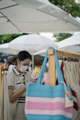 Series photo of young women choosing new shopping bag in street market , refreshing look concept