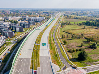 Naklejka premium Highway or Freeway road. Wide road with many lanes. Highway for any transportation. Road for cars and trucks Warsaw Poland roads. Panorama landscape. Aerial view. S2 Wilanow tunnel