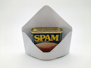 An envelope with spam in it, not digital spam but the canned ham type of spam symbolizing unwanted junk in your e-mail. - obrazy, fototapety, plakaty