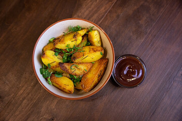 baked fried potatoes with herbs and red sauce