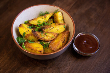 baked fried potatoes with herbs and red sauce