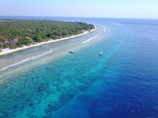 Fototapeta na wymiar Drone Gili island blue colors boat ship sunny day exotic destination coral corals landscape horizon 
