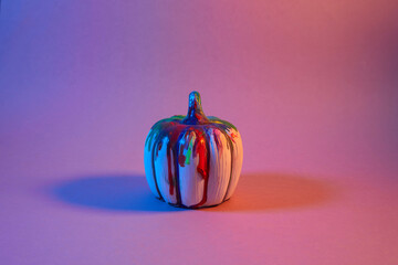 Halloween pumpkin with on neon light background. Minimal concept.