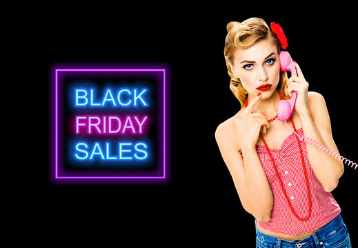 Portrait studio image - pensive, puzzled or thinking woman with phone tube. Unhappy pin up girl. Retro and vintage concept. Dark background. Black Friday sales neon light sign text.