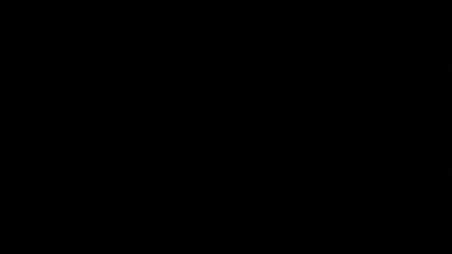 Expressive flow of small water drops on black background
