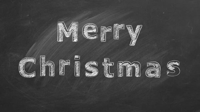 MERRY CHRISTMAS in chalk on a blackboard