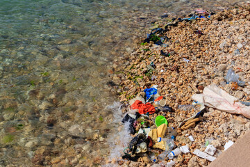 Garbage on a bank of ocean. Pollution of sea, ocean water with waste, plastics garbage. Concept of...