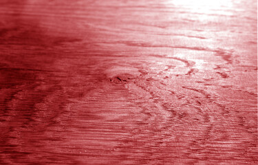 Old oak board texture as background with blur effect in red tone.