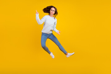 Fototapeta na wymiar Full body photo of unhappy upset young woman jump wear glasses finger point problem isolated on yellow color background