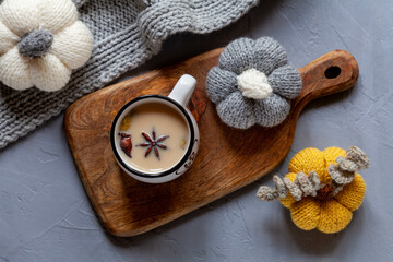Cup of spicy tea with milk, cozy home interior, flat lay