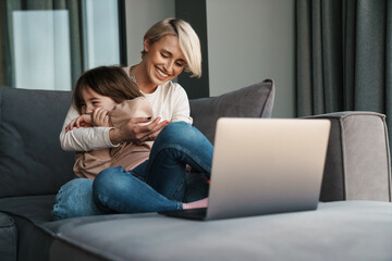 Happy young mother and her little daughter