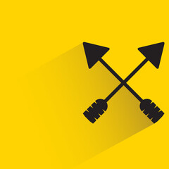 crossed hunting arrows with shadow on yellow background