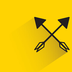crossed hunting arrows with shadow on yellow background