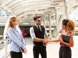 Businessman and woman shaking hands after discussing new project, outdoor