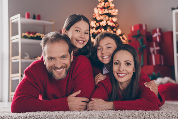 Naklejka premium Photo of cheerful family have fun xmas atmosphere spirit winter decor parent kid lying floor indoors