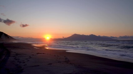 Obraz premium Amazing sunset and cloudy landscape in Kunashir, Kuril Islands. Timelapse.
