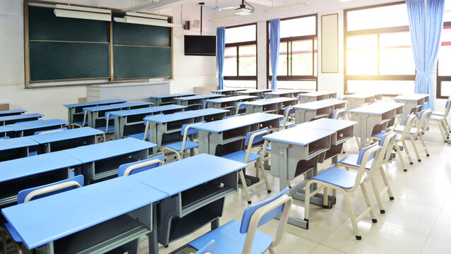 Empty classroom with blue desks and chairs