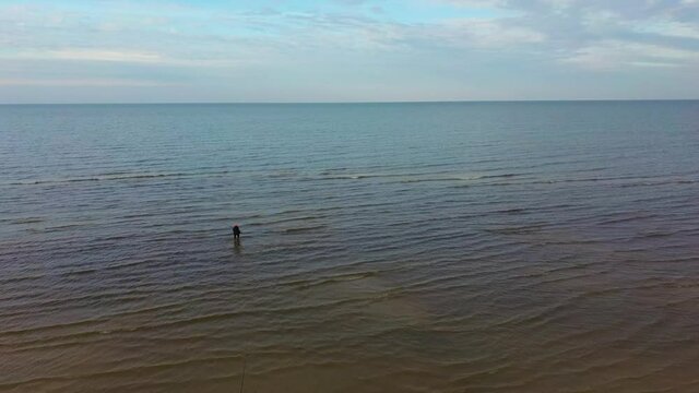 Fisherman Catches Flounder in the Kolka Cape, Baltic Sea, Latvia. Aerial View During Autumn Evening Sunset. Kolka Horn Divides Baltic Sea and Riga Bay.