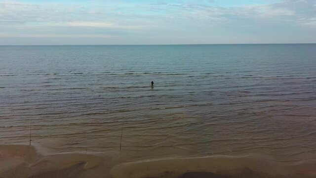 Fisherman Catches Flounder in the Kolka Cape, Baltic Sea, Latvia. Aerial View During Autumn Evening Sunset. Kolka Horn Divides Baltic Sea and Riga Bay.