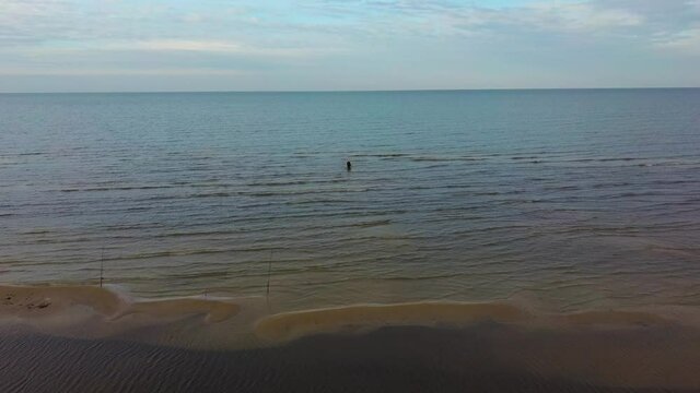 Fisherman Catches Flounder in the Kolka Cape, Baltic Sea, Latvia. Aerial View During Autumn Evening Sunset. Kolka Horn Divides Baltic Sea and Riga Bay.