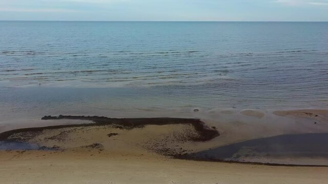 Fisherman Catches Flounder in the Kolka Cape, Baltic Sea, Latvia. Aerial View During Autumn Evening Sunset. Kolka Horn Divides Baltic Sea and Riga Bay.