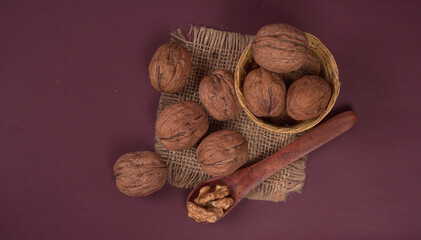 closeup photo of a walnut seed in wooden bowl. Food that is good for brain and lower risk of heart disease.