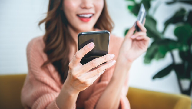 Blurred soft images of Asian attractive woman using mobile phones for shopping online with happy, to business people and shopping online concept.