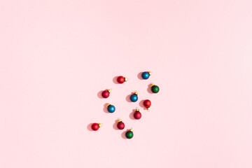 Christmas balls on pink pastel paper backgrond with copy space