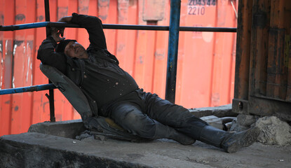 dirty homeless man sleeping on the street