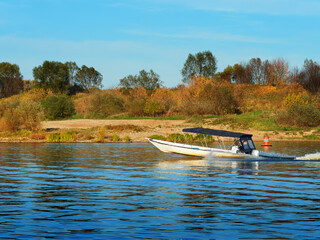 Fast boat at autumn river travel background