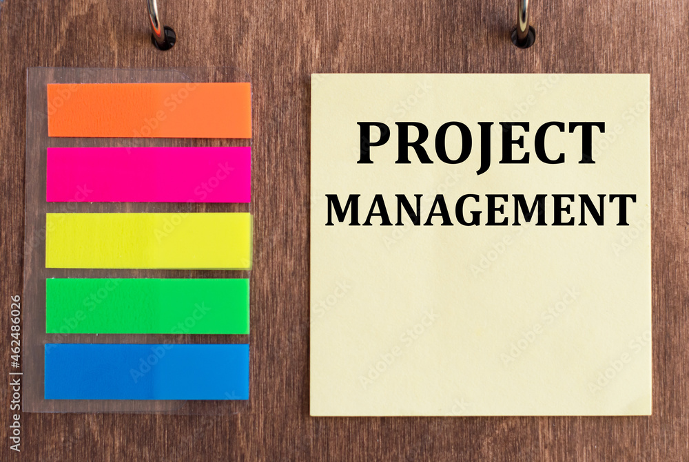 Poster a card with text project management lying on a wooden background