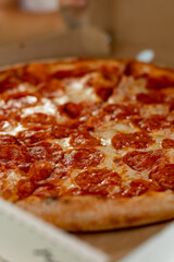 Hot, delicious pizza is waiting to be eaten. Cheese pizza with sausage. Delicious food with delivery.