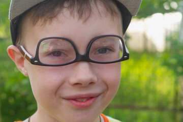 Funny caucasian teen boy in inverted glasses jokes and laughs