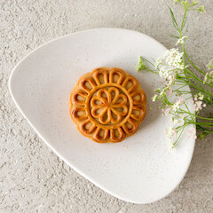 a plate with a cupcake on a light table