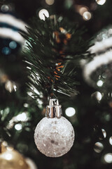 Christmas toy silver shiny ball hanging on the Christmas tree