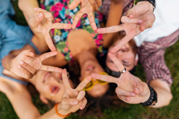 happy young company of friends sitting park