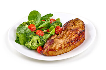 Roasted pork steaks with vegetable salad, isolated on white background.