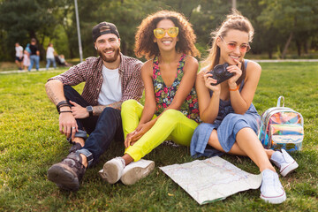 happy young company of friends sitting park