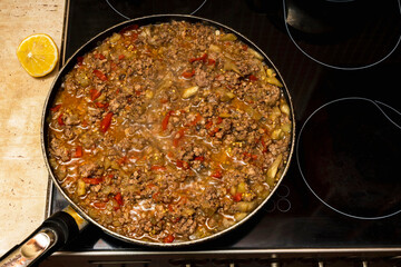 meat with vegetables is stewed on the stove in a frying pan, home cooking, delicious and nutritious food