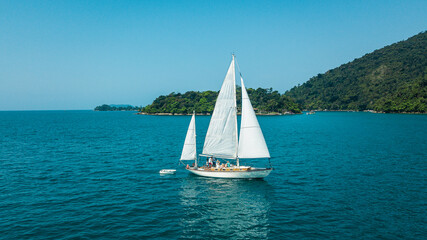Beautiful classic sailboat sailing through the Paraty Bay, Rio de Janeiro, Brazil.