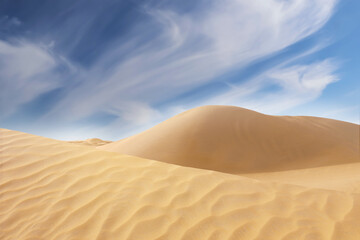 Picturesque view of sandy desert and blue sky on hot sunny day