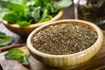 powdered mint leaves, preparation for mint tea in recycled wooden bowl