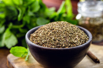 powdered mint leaves, preparation for mint tea in clay bowl