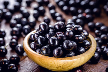 bowl with many jabuticabas, exotic south american grape native to brazil, bolivia and argentina